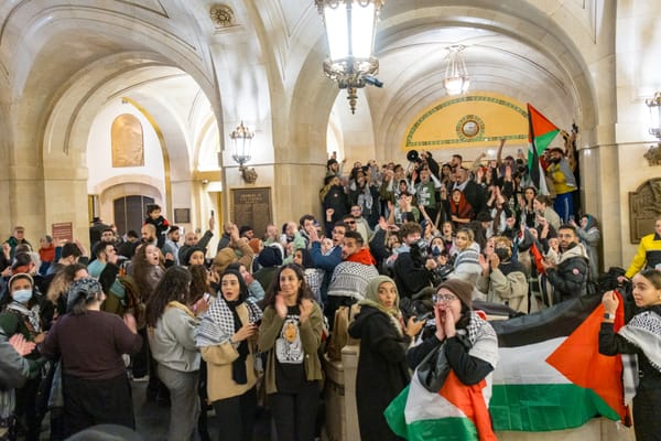 A crowd of Palestine solidarity protesters fill corridors at Chicago's City Hall
